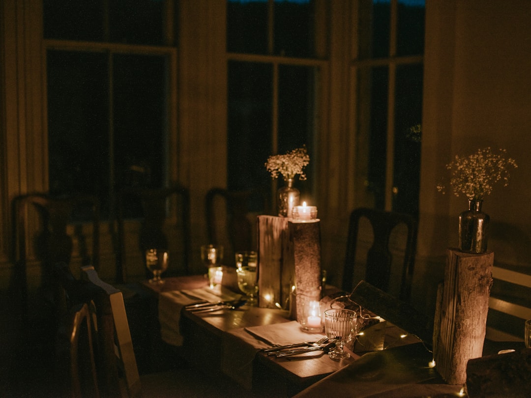 Warm candlelit farm table set for an intimate dinner